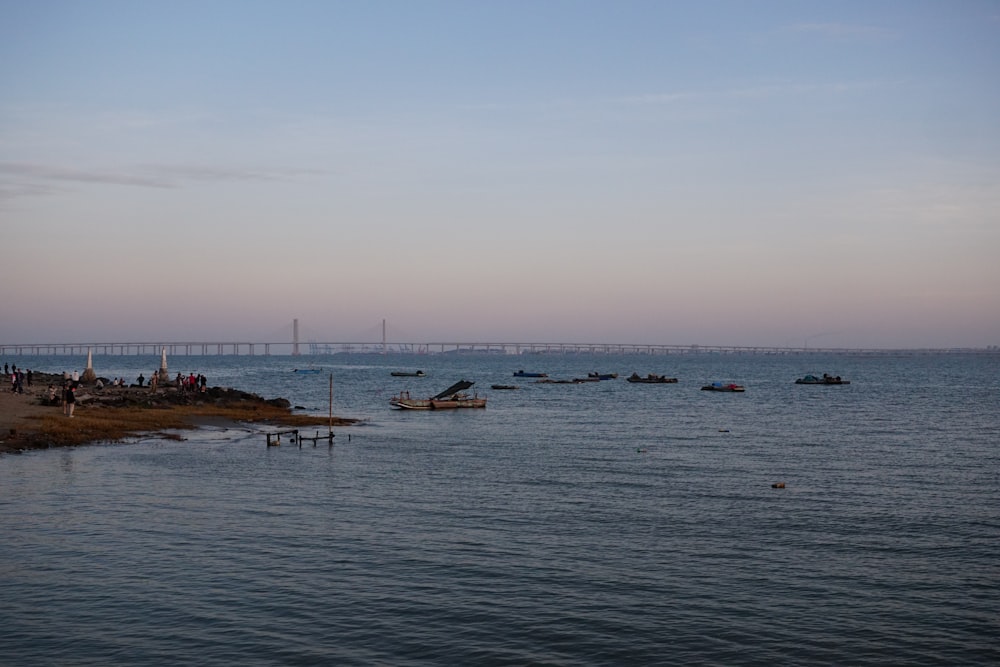 a body of water with a bridge in the background