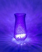 Unique home decor piece featuring a mosaic glass vase illuminated by natural light.