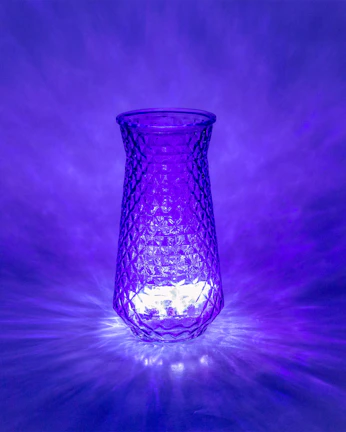 A creative glass vase glowing softly under warm lighting, perfect for modern decor.