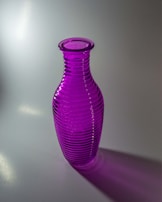 A vibrant purple glass vase catching the light, showcasing subtle color gradients.