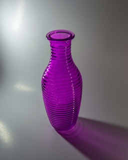 A vibrant purple glass vase catching the light, showcasing subtle color gradients.