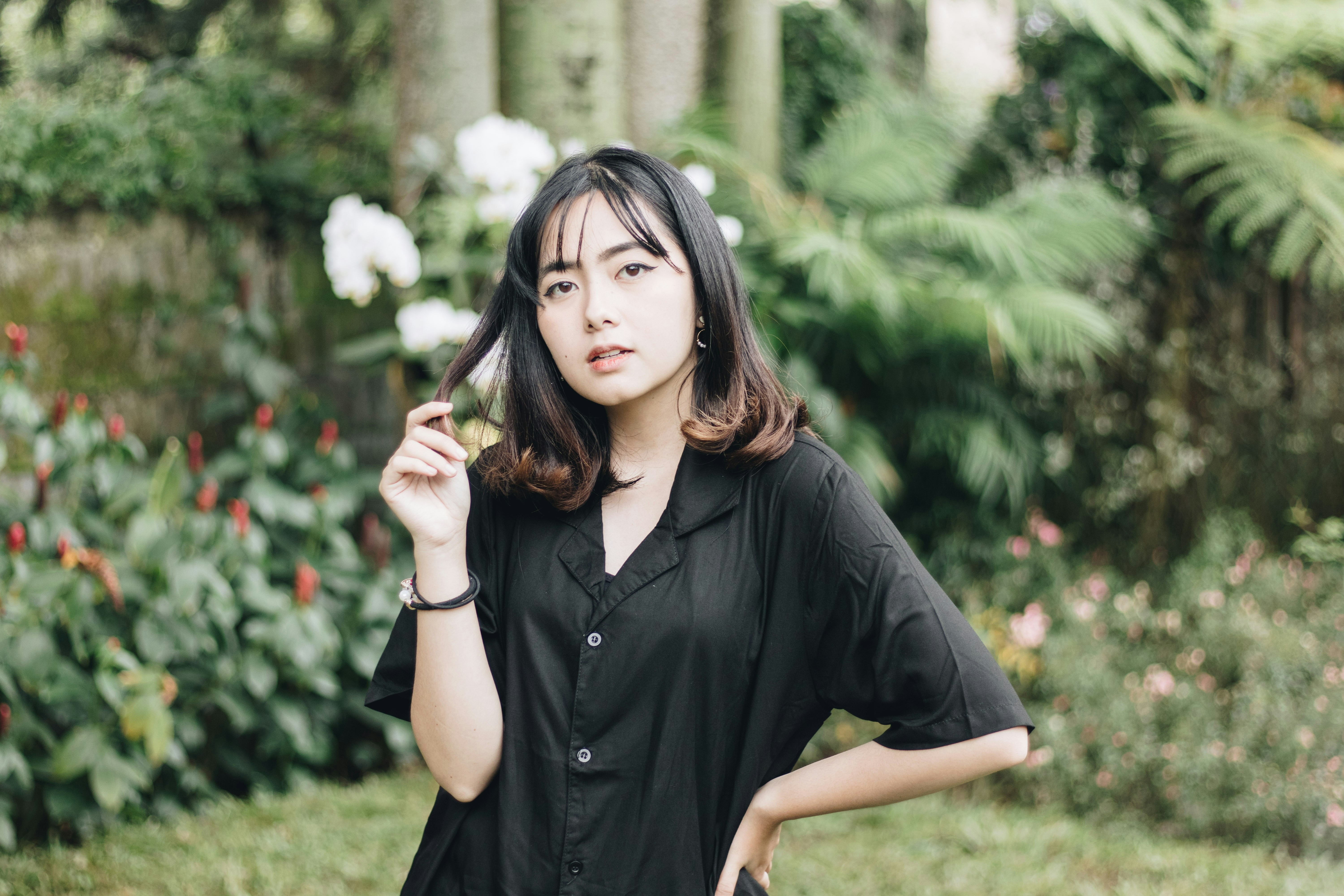 a woman in a black shirt is posing for a picture