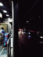 An Iron Hawk Security guard patrolling a commercial property at dusk with a watchful stance.