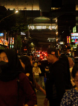 Screenshot of a bustling Tunisian Hoods Roleplay street scene at night with neon red and black lighting.