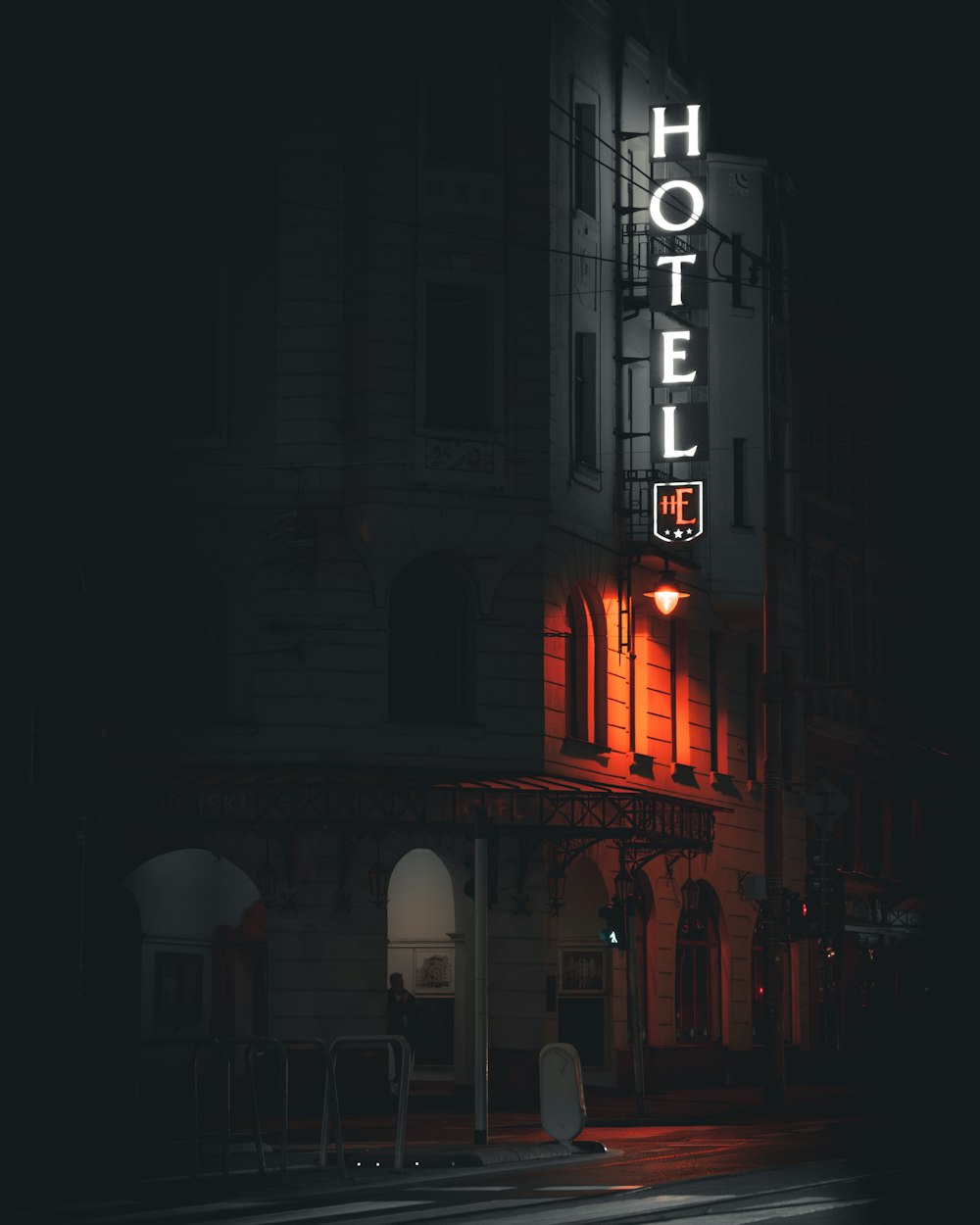 a hotel sign lit up at night on the side of a building