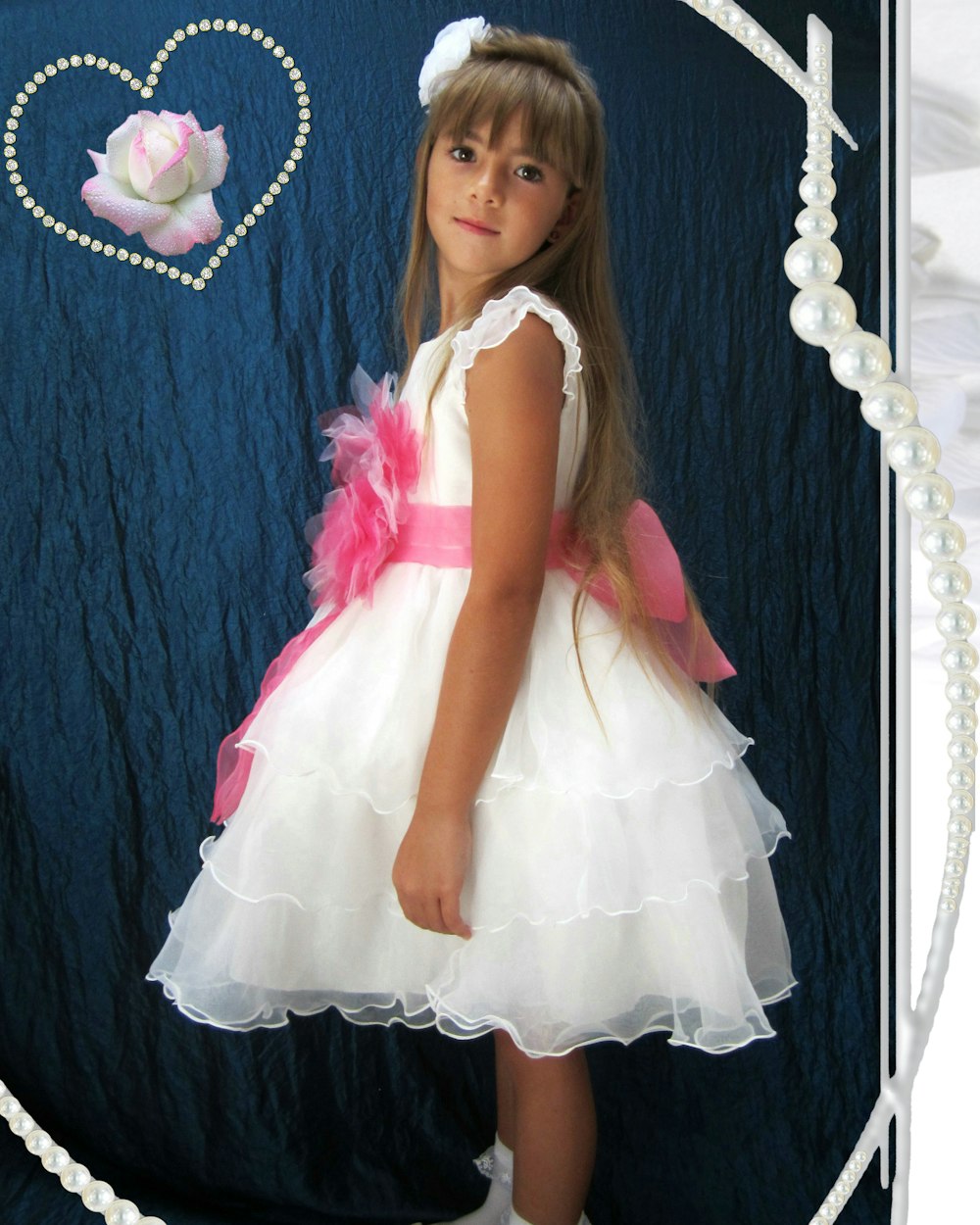 a little girl in a white dress with a pink bow
