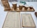 A selection of coffee items on a white countertop includes a bag of coffee, four paper cups with a percentage symbol, two clipboards with menus or price lists, tablets in the background likely for orders, and a hint of electronic equipment for transactions.