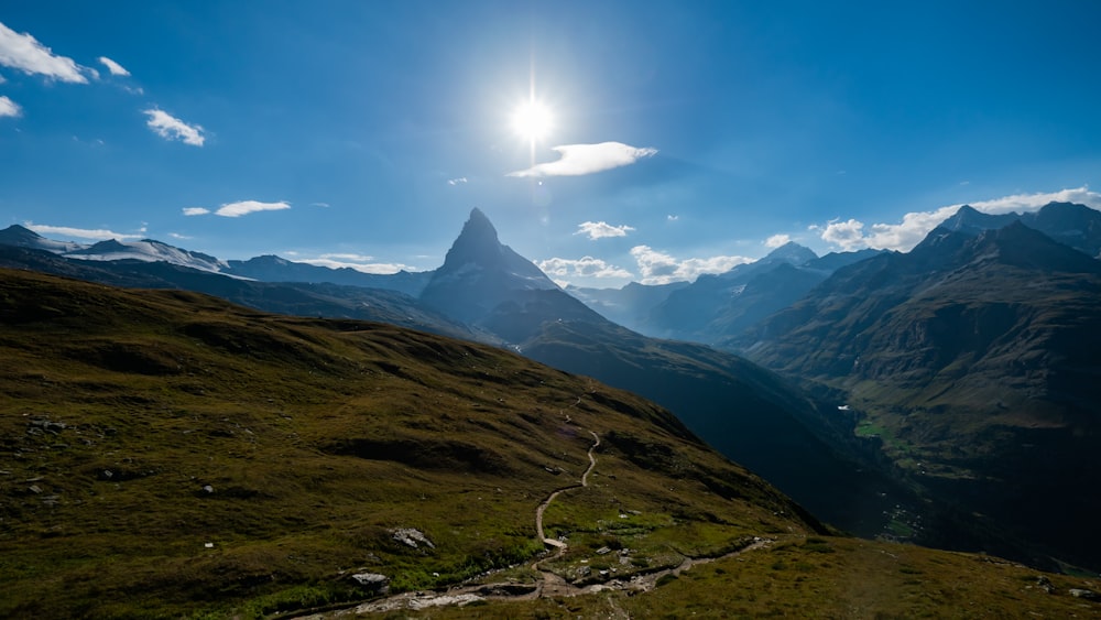 the sun is shining over a mountain range