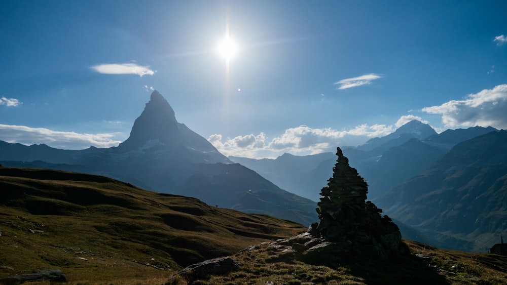 the sun is shining over a mountain range