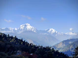 A serene view of snow-capped Himalayan peaks under a clear blue sky