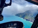 A helicopter hovering above a scenic coastal view.