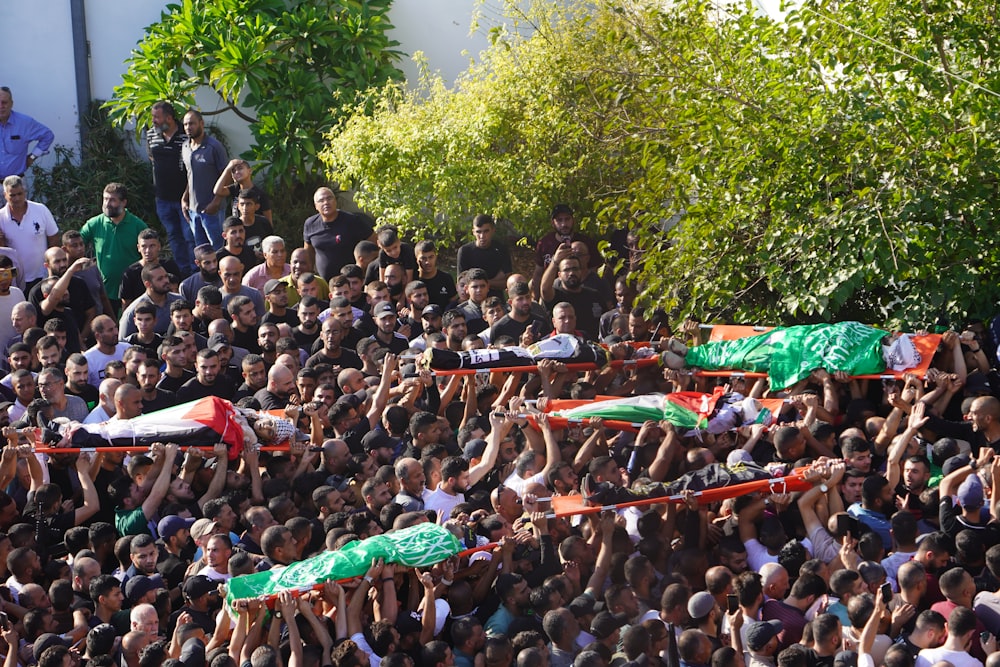 a large crowd of people are watching a soccer match