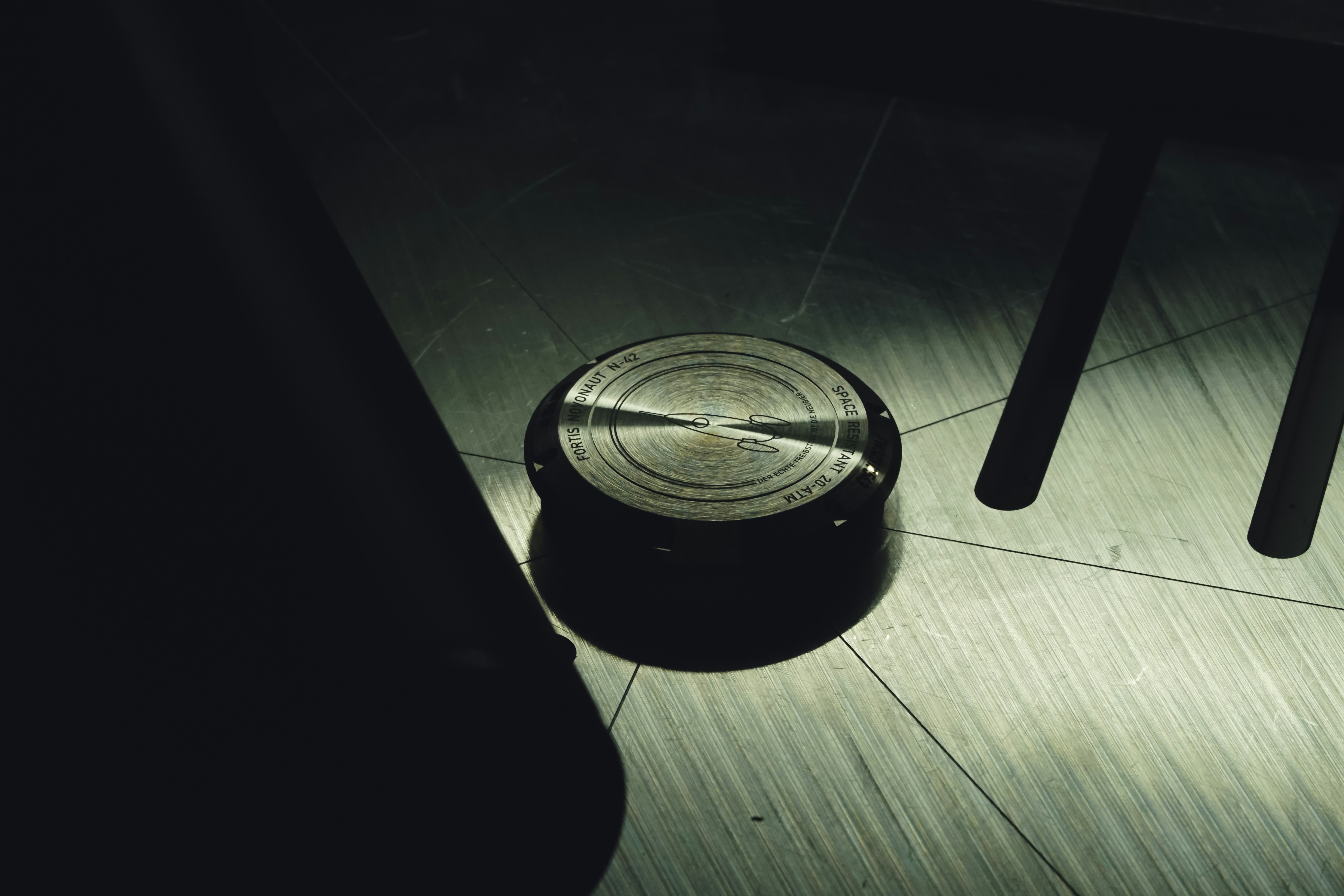 a metal object sitting on top of a wooden floor