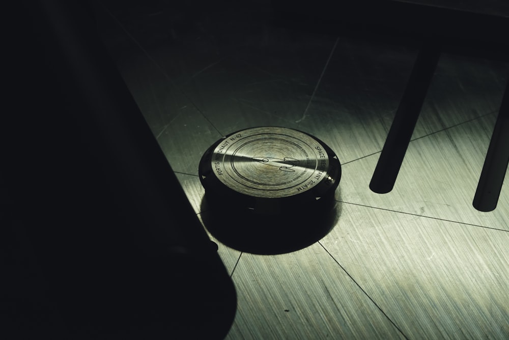 a metal object sitting on top of a wooden floor