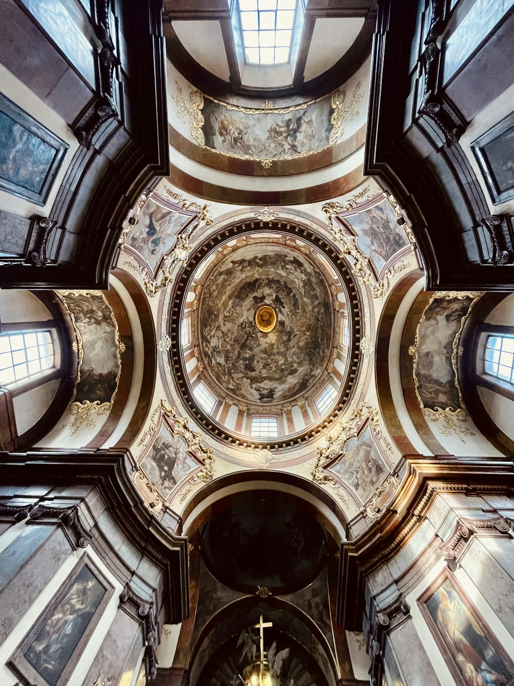 the ceiling of a church with paintings on it