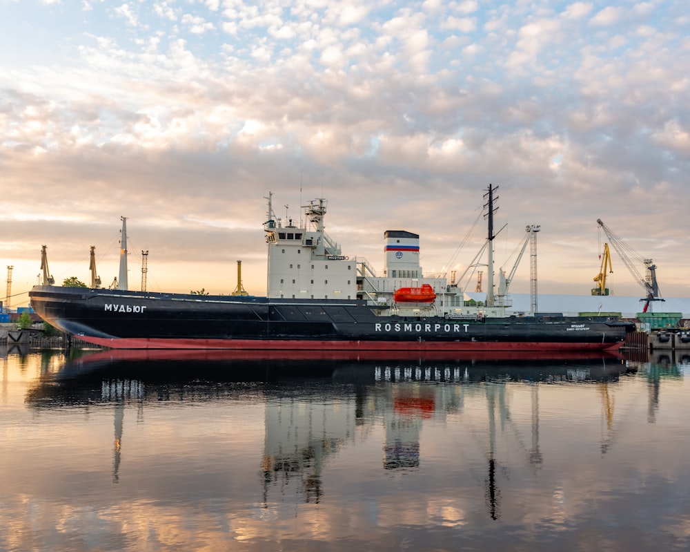 a large boat sitting in the middle of a body of water