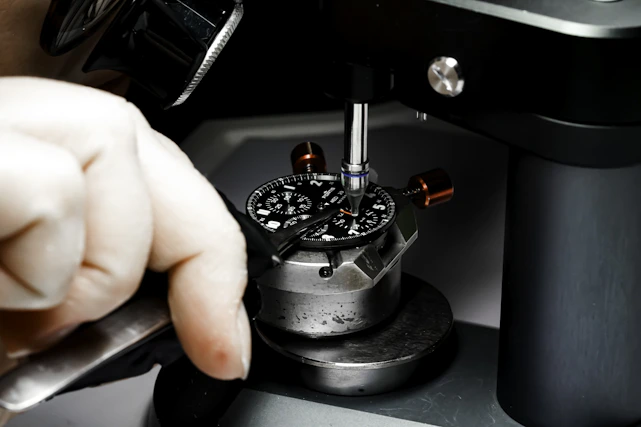 Close-up of a skilled millwright adjusting heavy industrial machinery with precision tools.
