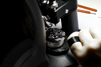 a person is looking through a microscope at something