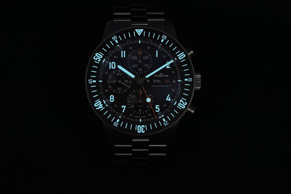 a close up of a watch on a black background