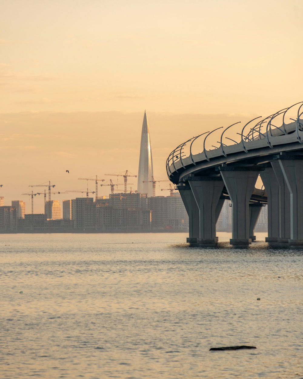 a bridge over a body of water with a building in the background