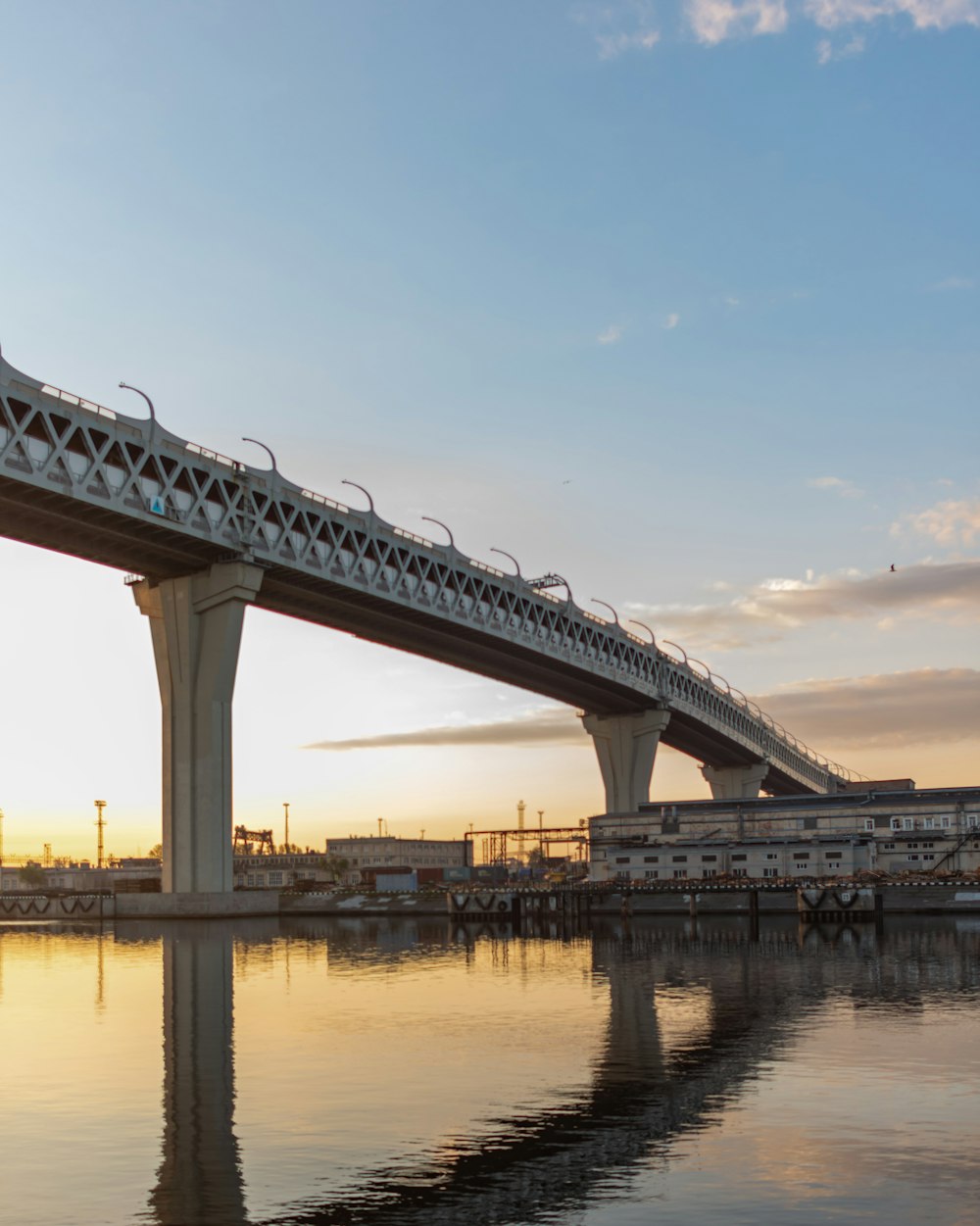 a bridge over a body of water at sunset