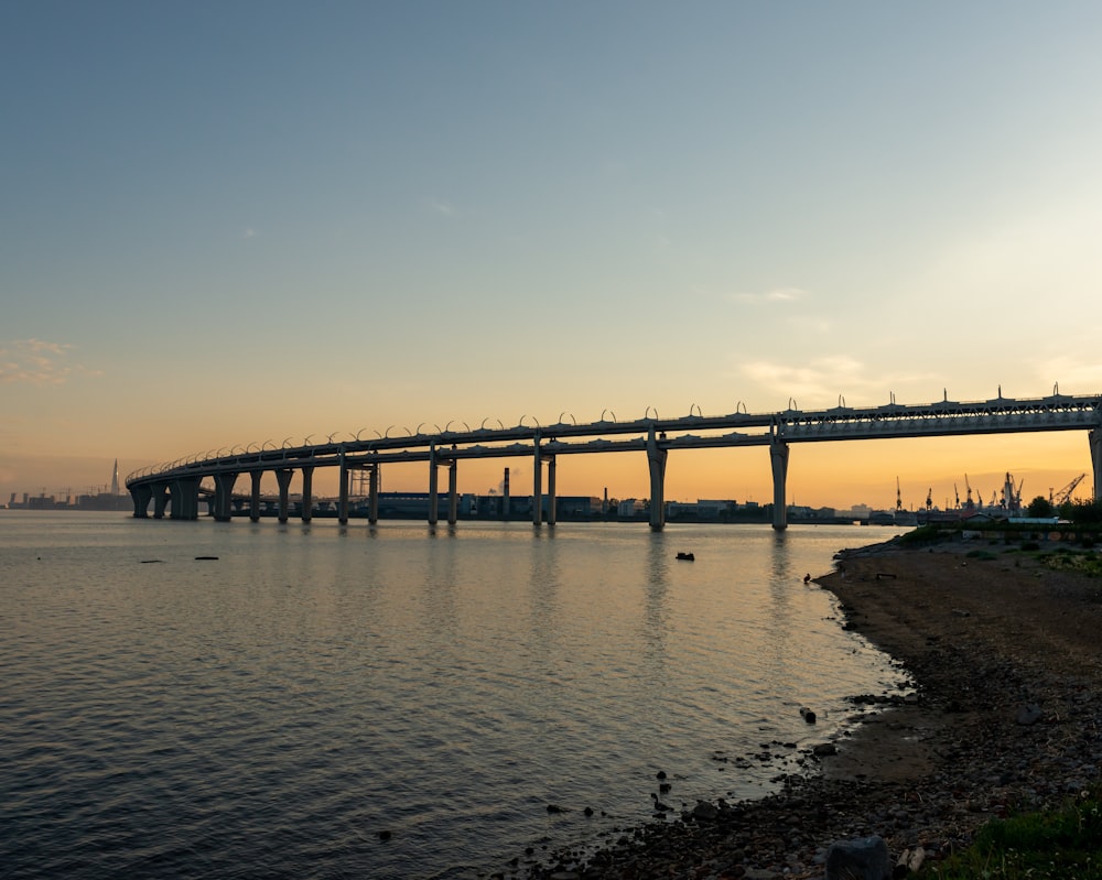 a bridge over a body of water at sunset