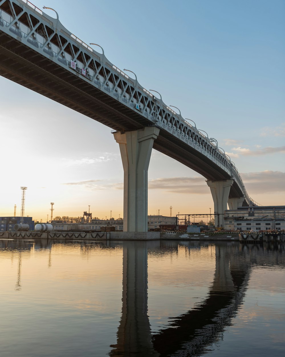 a bridge over a body of water at sunset