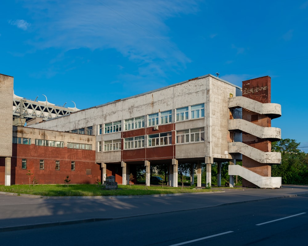 a large building with a lot of windows next to a street