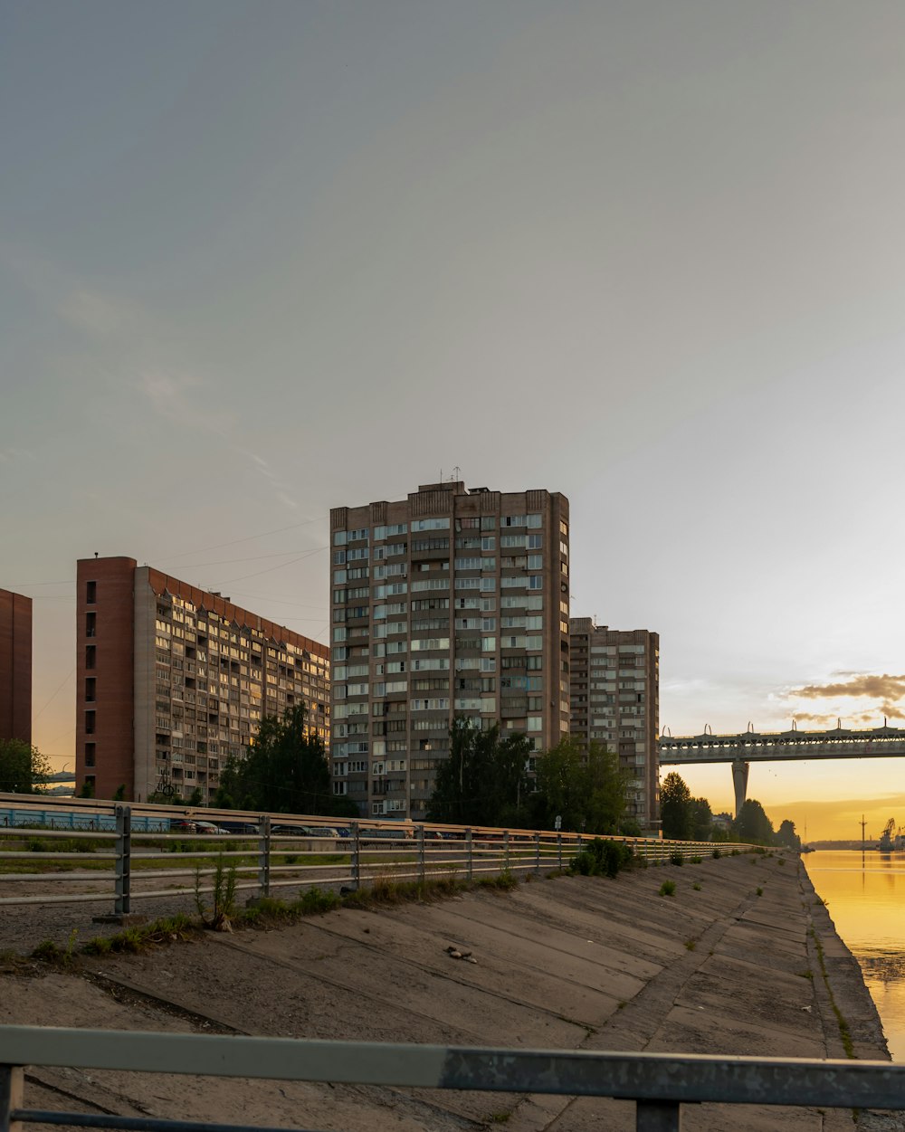 a bridge over a body of water next to tall buildings