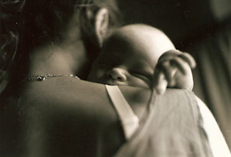 a woman holding a baby in her arms