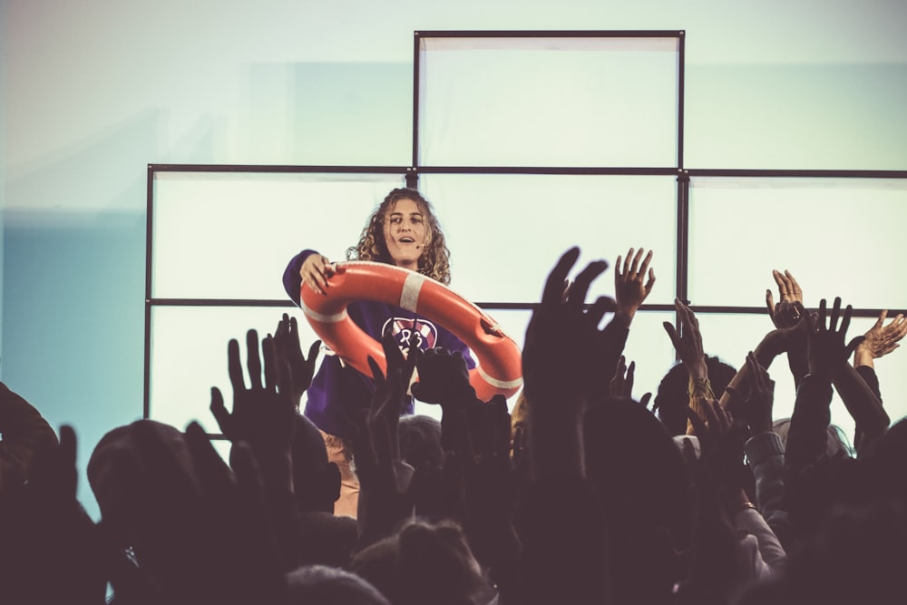 a woman is holding a balloon in the air