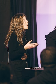 a woman standing in front of a microphone