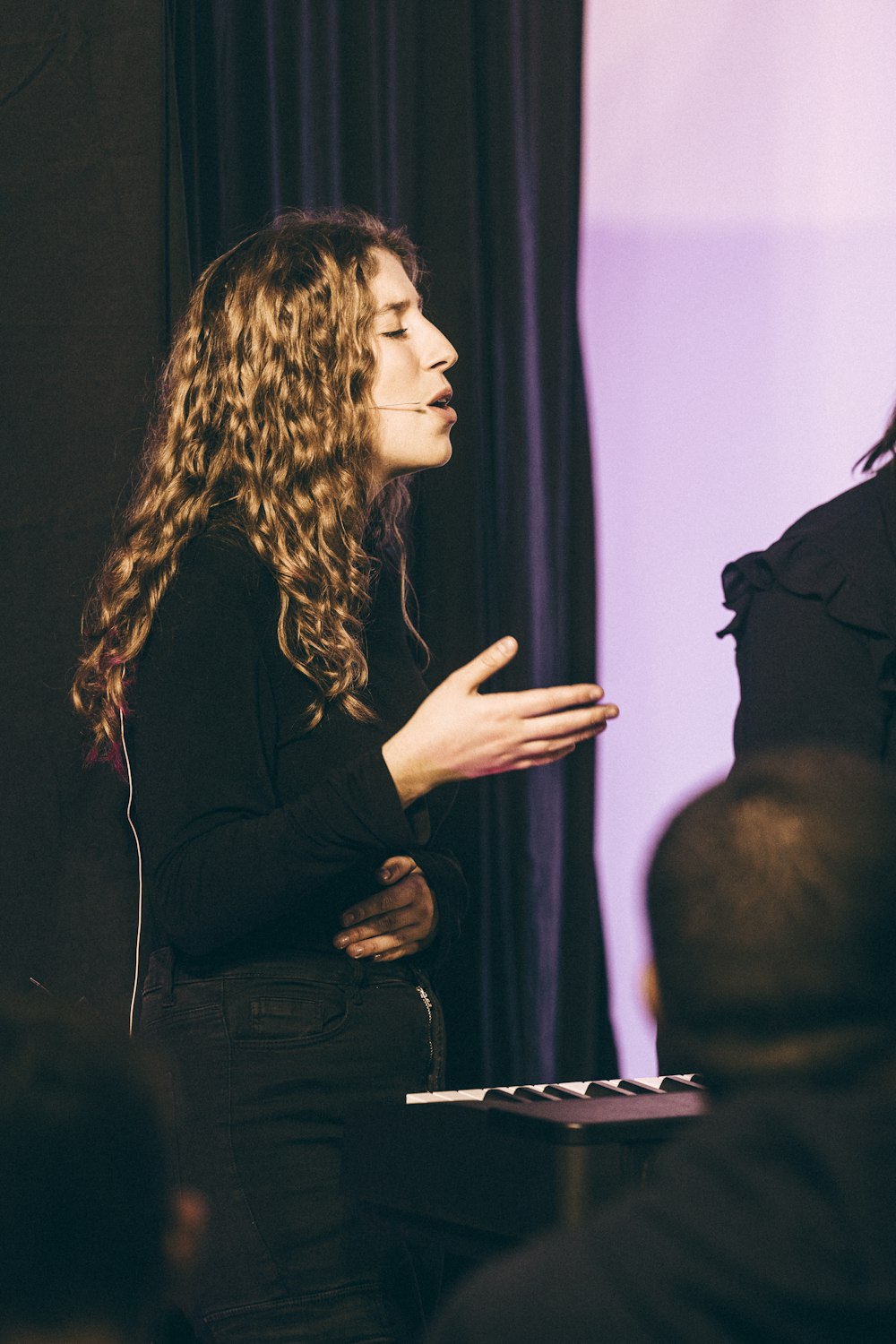 a woman standing in front of a microphone