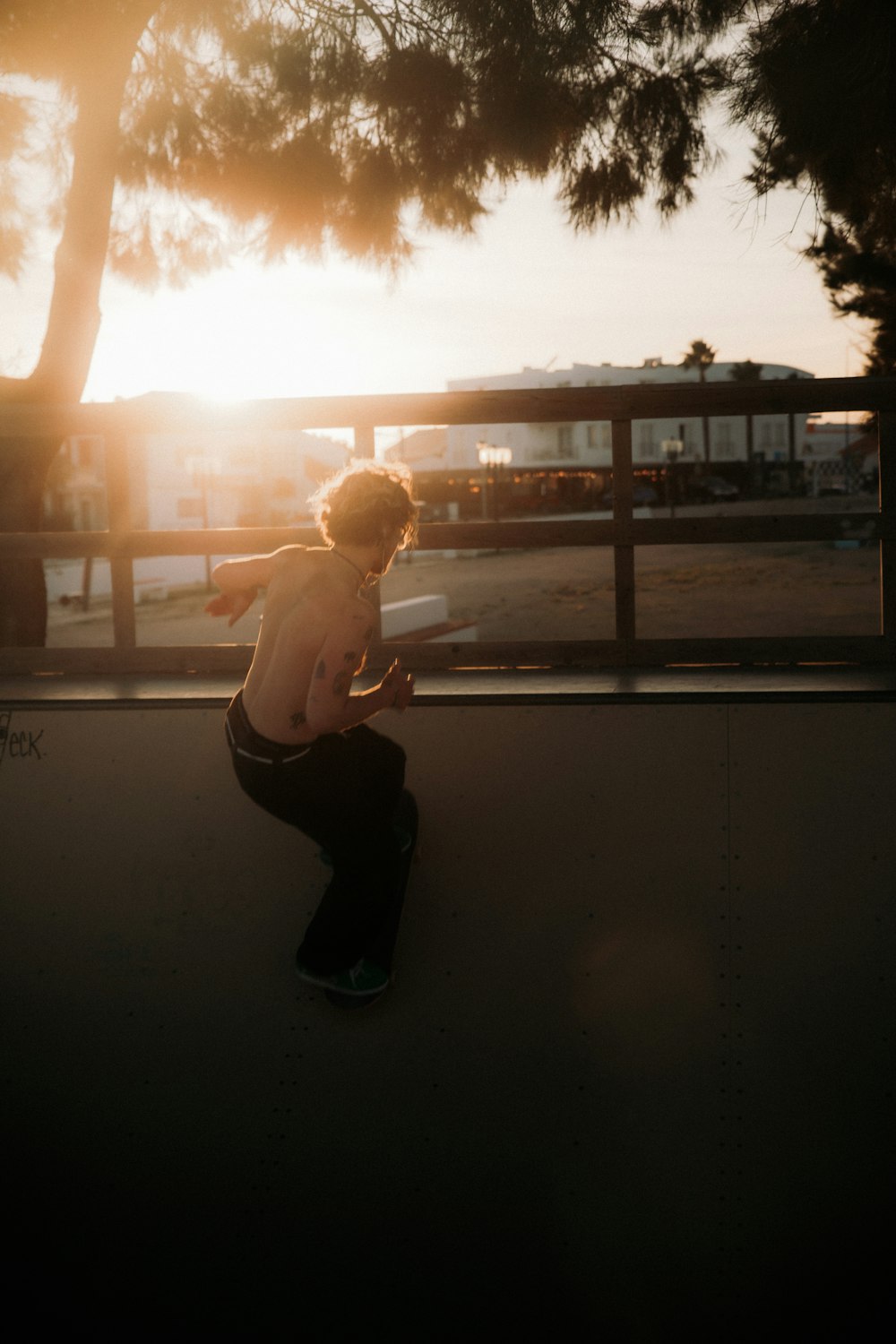 a man riding a skateboard on top of a cement wall