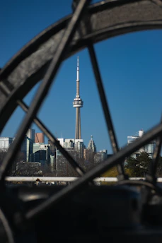 A clean vehicle cruising past Toronto’s iconic CN Tower on a clear day.