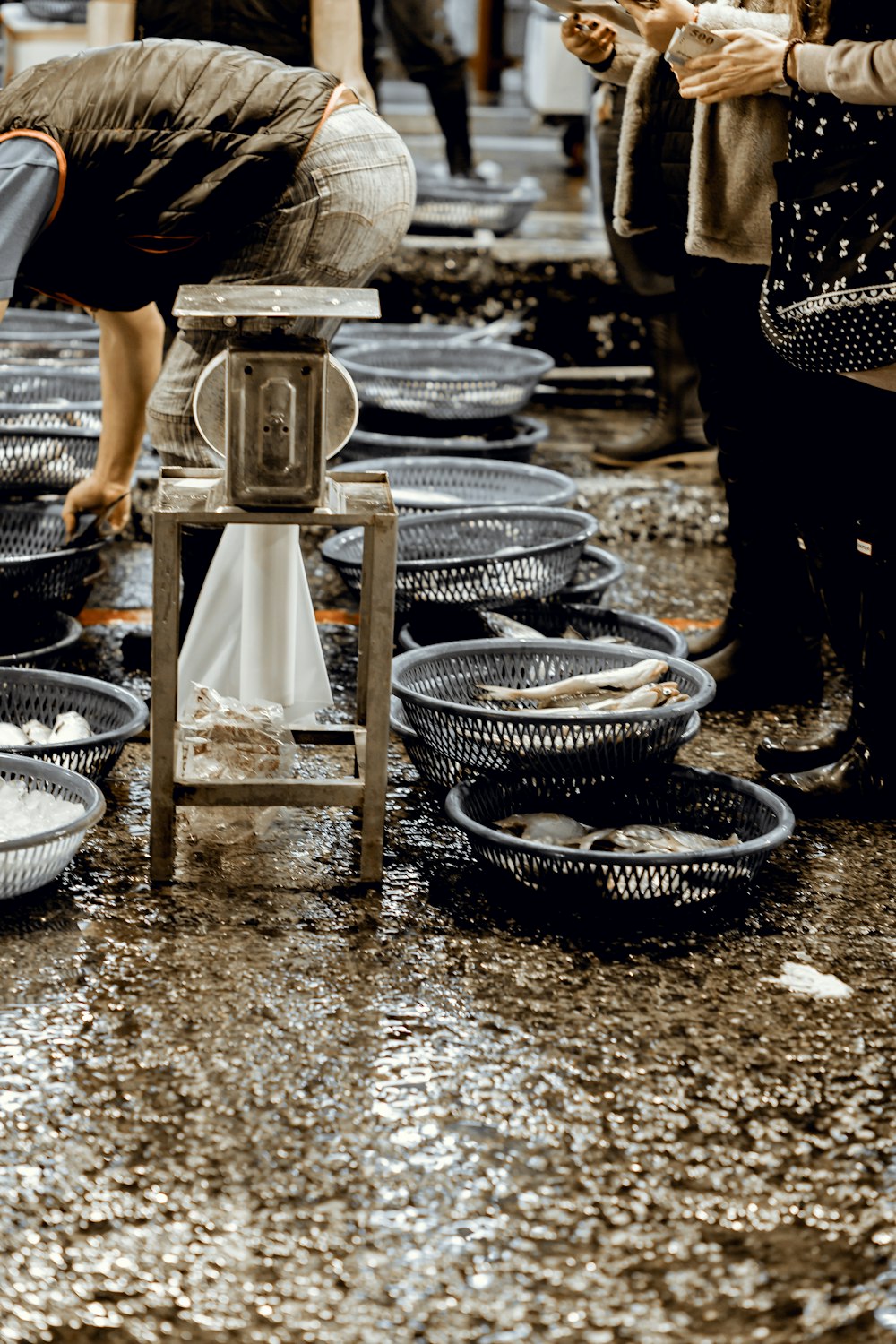 a group of people standing around a table filled with bowls