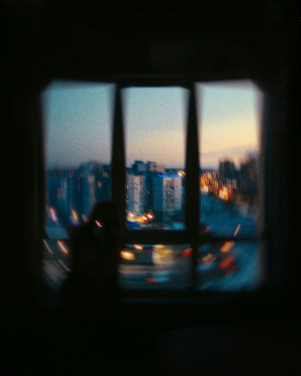 a window with a view of a city at night