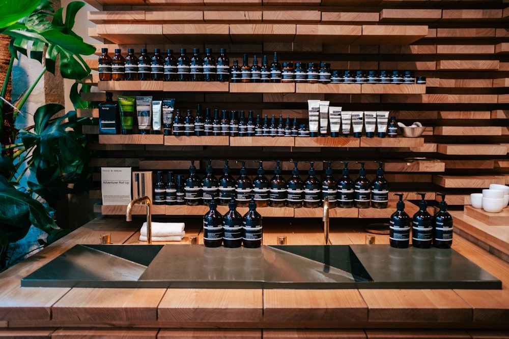 a display of bottles of wine on a wooden shelf