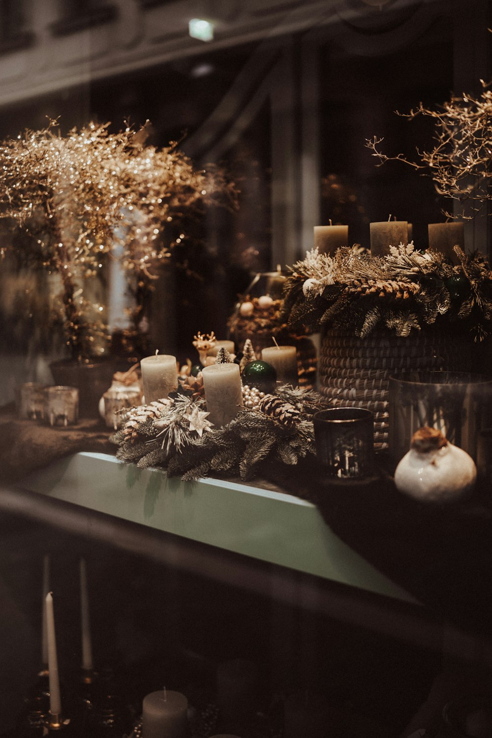 a window display with candles and christmas decorations