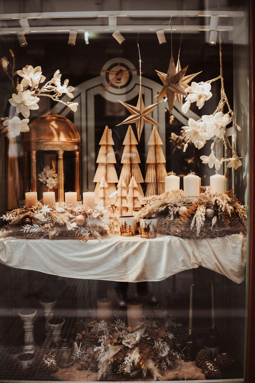 a display case with candles and christmas decorations