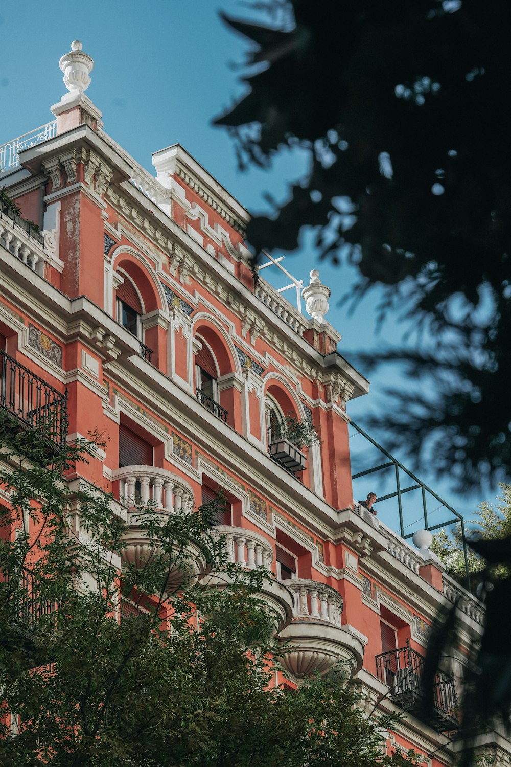 a red building with a balcony and balconies