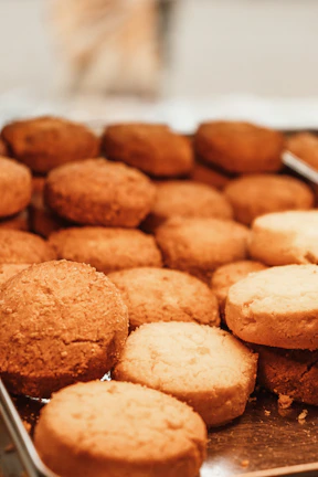 Gourmet close-up of signature cookies with warm gold accents highlighting texture and detail.