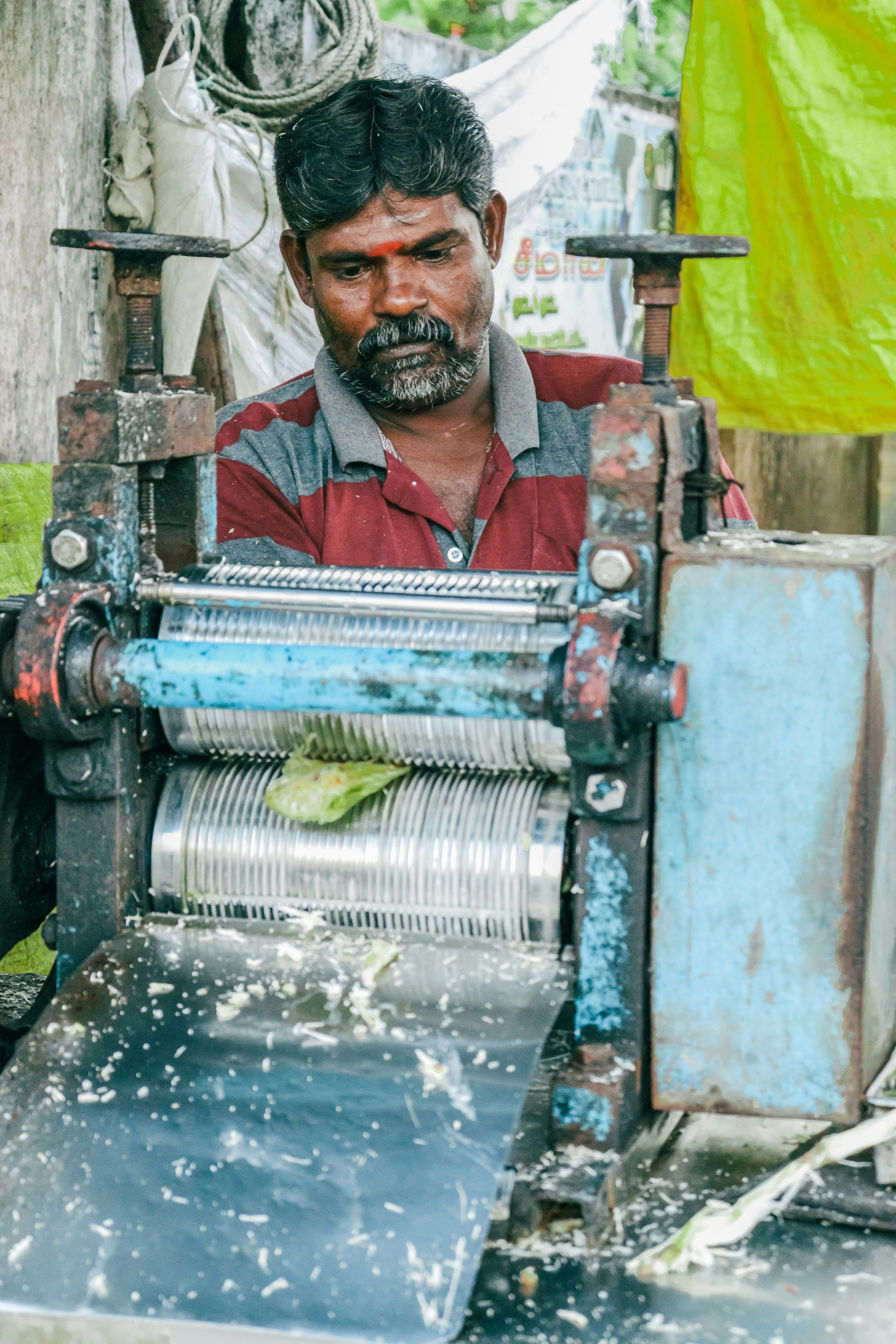 a man sitting in front of a spinning machine