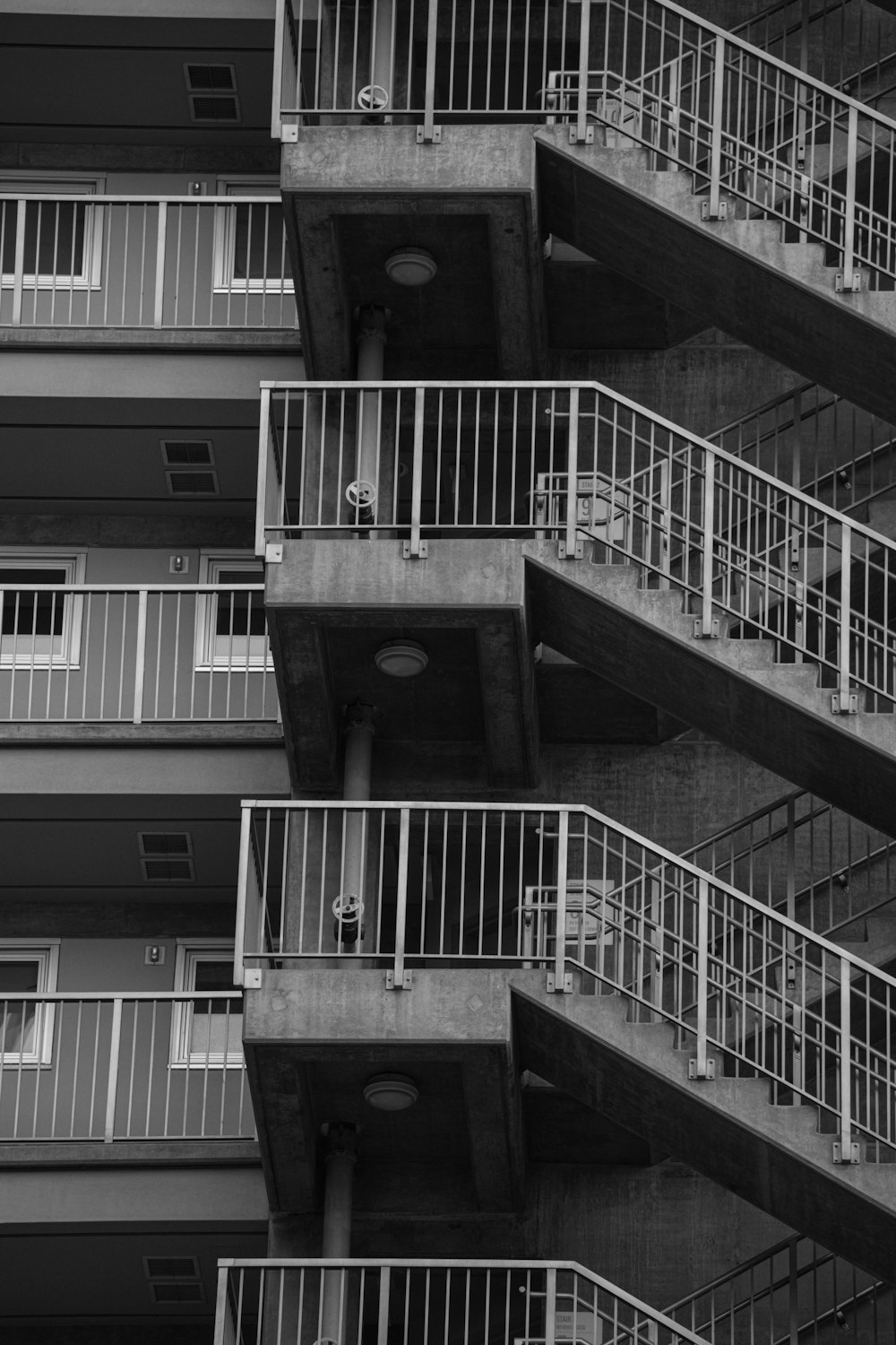 a black and white photo of a building with balconies