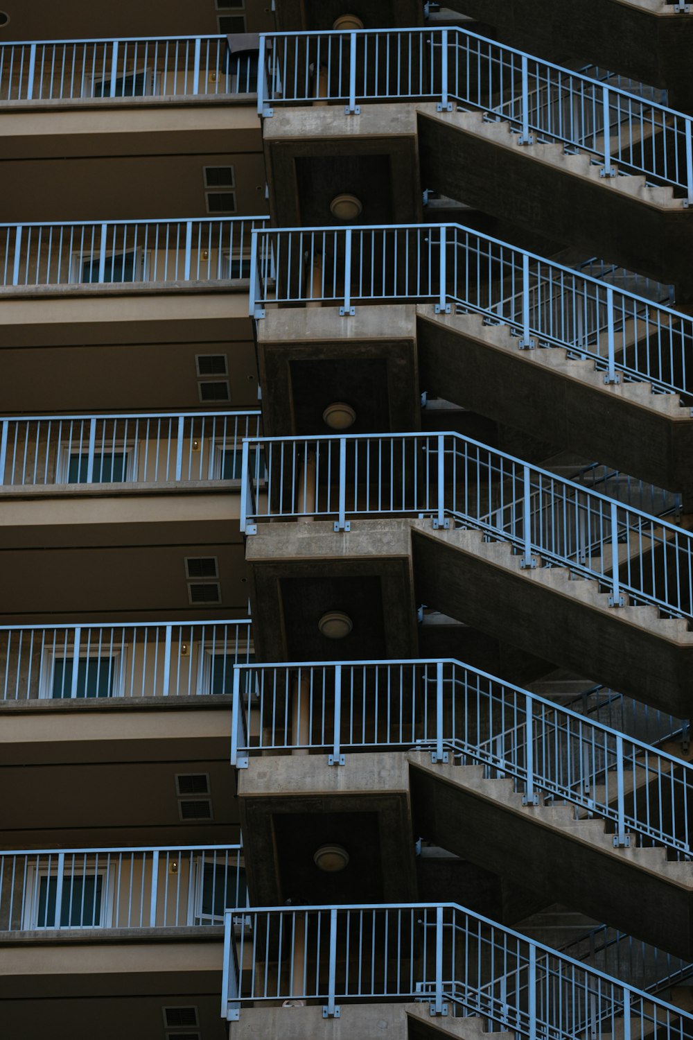 a very tall building with balconies and a clock