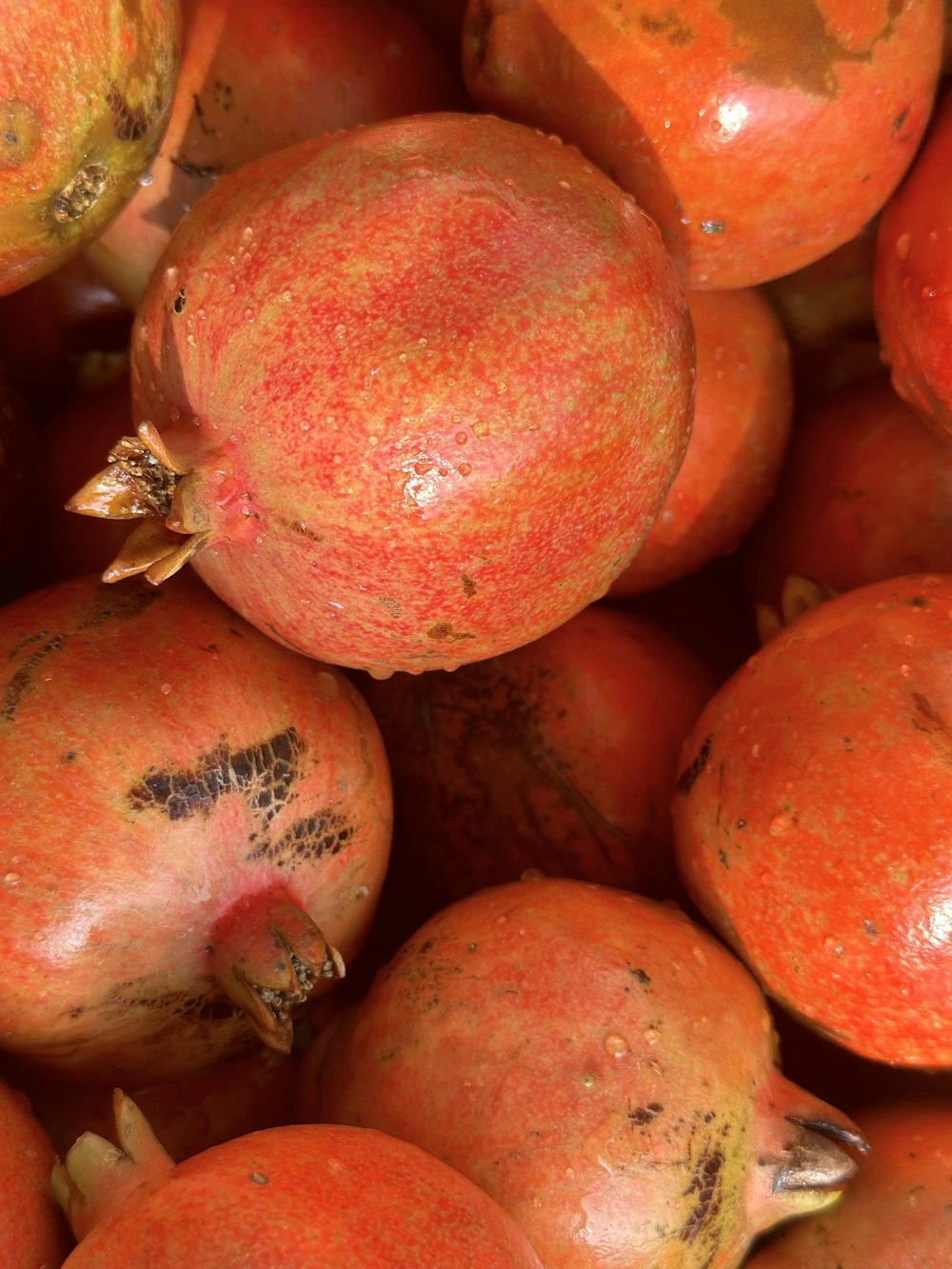 a pile of pomegranates sitting on top of each other