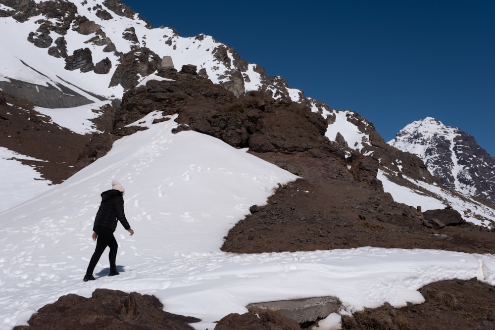 a person standing in the snow on a mountain