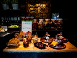 Rustic wooden table displaying artisanal Minas Gerais cheeses and goiabada under warm natural light.