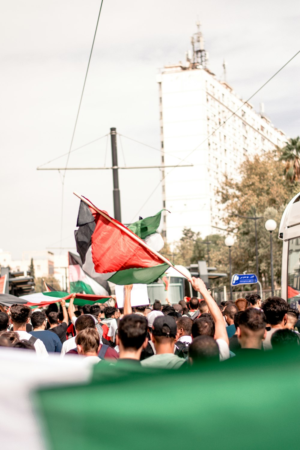 a crowd of people standing next to a bus