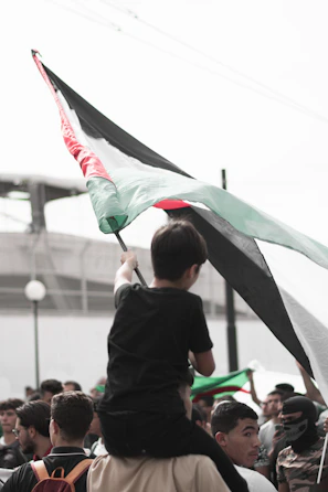 A close-up of the team captain holding the club flag during a passionate pre-match ceremony.